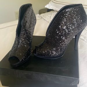 Black bootie like heels with open toe, worn once in very new condition